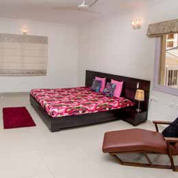Bed Room: Conservatively done up bedroom with a cosy bed and television at Concord Gachibowli Serviced Apartment