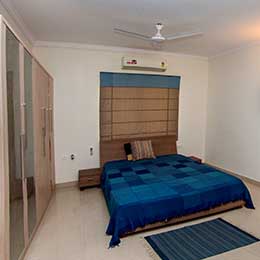 Bed Room: Fully air-conditioned and uncluttered bedroom provides a serene ambience at Concord Gachibowli Serviced Apartment